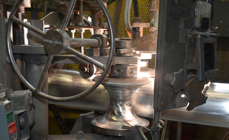 Welded aluminum pipe moving in a roll former