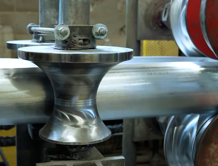 Aluminum pipe being in a roll former being welded
